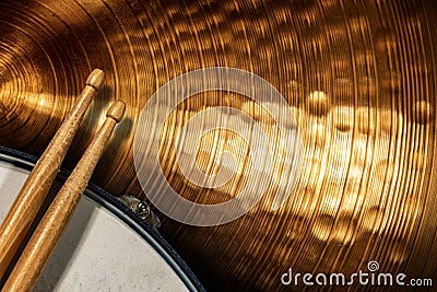 Two wooden drumsticks on a snare drum and golden cymbal - Percussion instrument Stock Photo