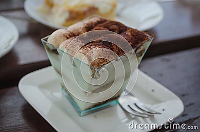 Close up of typical Italian sweet pastry - Tiramisu with mascarpone in transparent cup Stock Photo