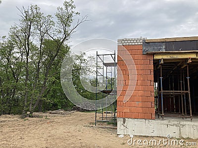 Close up of unfinished house in residential area. Modern architecture of construction brick house for comfortable stay Stock Photo