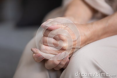 Close up unhappy lonely mature woman folded hands together Stock Photo