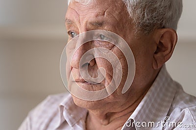 Close up unhappy lonely thoughtful older man looking in distance Stock Photo