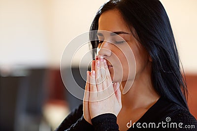 Close up of unhappy woman praying god at funeral Stock Photo