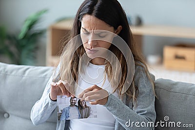 Close up unhappy woman tearing picture with boyfriend, break up Stock Photo