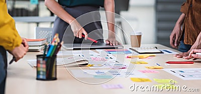 Close up ux developer and ui designer brainstorming about mobile app interface wireframe design on table with customer brief and Stock Photo