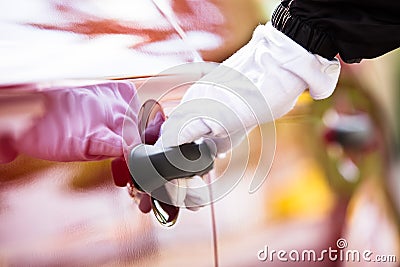 Valet Opening Car Door Stock Photo