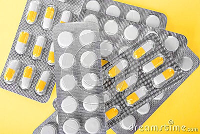 A close-up variety of healthful meds. A close-up of packs with tablets on a sunny background. Prescripted organic capsules. Stock Photo