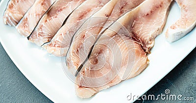 Close-up of various slices of raw swordfish, in a white plate, on a slate table..Tasty food from Italian cuisine and from the Stock Photo