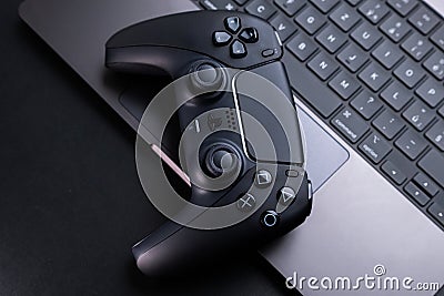 Close Up of Video Game Controller Near Laptop Editorial Stock Photo