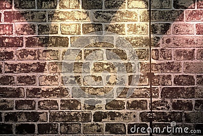 Close up view at an aged brick wall with some bright colored spot lights Stock Photo