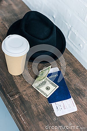 close up view of arranged passport, cash, coffee to go and hat Stock Photo