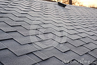 Close up view on Asphalt Roofing Shingles Background. Roof Shingles - Roofing. Shingles roof damage covered with frost. Stock Photo