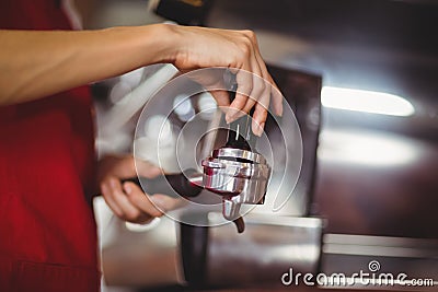 Close up view of a barista pressing coffee Stock Photo