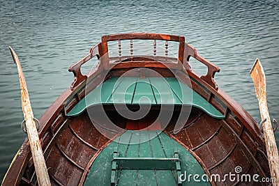 Close up view on beautiful wooden flat rowing boat with oars on lake bled, slovenia, go green concept Stock Photo