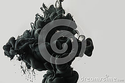 close up view of black paint splash in water isolated on gray Stock Photo