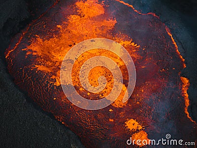 Close up view of boiling lava lake inside volcano crater, drone top down shot Stock Photo
