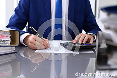 Close up view of bookkeeper or financial inspector hands making report, calculating or checking balance Stock Photo