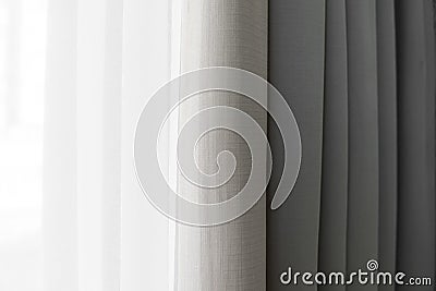 Close-up view of bright curtain in thin and thick vertical folds made of dense fabric.Textured abstract backgrounds and Stock Photo