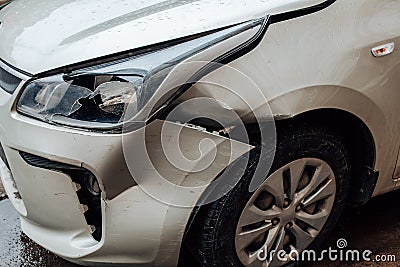 Close up view of broken bumper and damage to the auto after road accident. Car damage insurance, repair of bumpers and paintwork Stock Photo