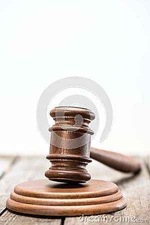 Close-up view of brown wooden mallet of judge on white Stock Photo
