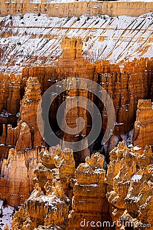 Close up view of bryce canyon national park hoodoos in winter in souther utah usa showing oranges and whites during the day Stock Photo