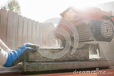 Close up view of a building contractor using an angle grinder or Stock Photo