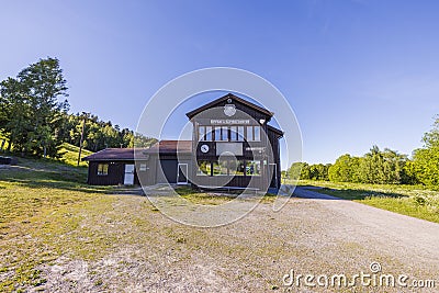 Close up view of building of sport center on blue sky and green trees background. Uppsala. Sweden. Editorial Stock Photo