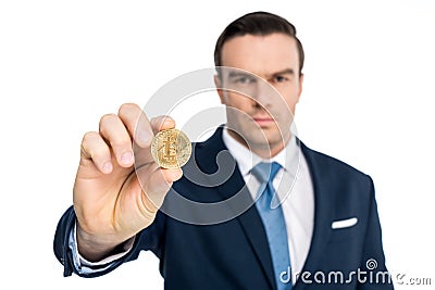 close-up view of businessman holding bitcoin and looking at camera Editorial Stock Photo