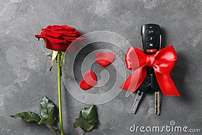 Close-up view of car keys with red bow as present on wooden background. Love confession. Valentine`s day Stock Photo