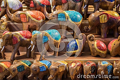 Carved wooden elephants selling in the souvenirs stall at Ratchada Rot Fai Train Night Market Bangkok Stock Photo