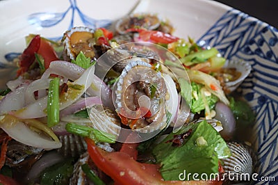 CLOSE UP view , Cockles salad / Hot and spicy shellfish blood cockles salad mix vegetable tomato herb and spices , thai style food Stock Photo