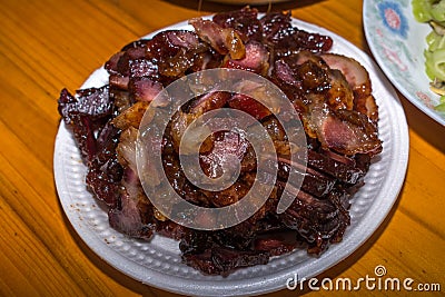 Close-Up View on Cooked Pork. Southern Chinese Festivity Rural Food on Bowls and Plates at a Wooden Table Stock Photo