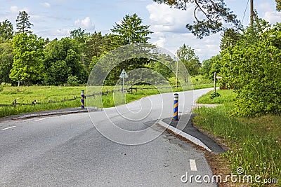 Close-up view of country road with speed limit by compulsion to slow download because of road narrows. Stock Photo