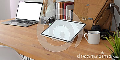 Close-up view of cozy photographer workspace with mock up digital tablet and laptop computer with office supplies Stock Photo