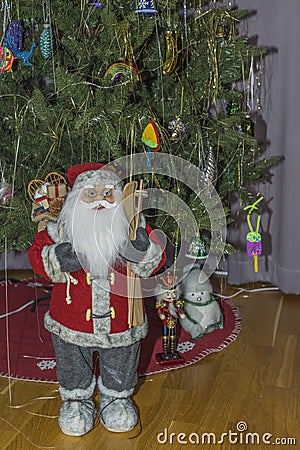 Close up view of cute figure of Santa Claus on background of Christmas tree. Stock Photo