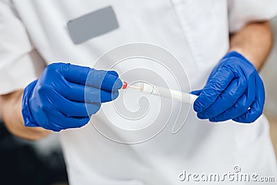 Close up view of DNA swab of saliva in doctors hands Stock Photo