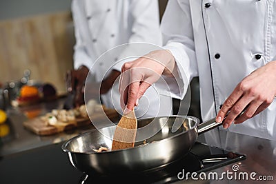 Close-up view of female chef cooking Stock Photo