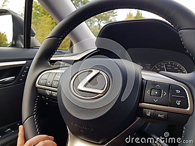 Close up view of female hand on steering wheel of Lexus RX car. Vehicle concept. Editorial Stock Photo