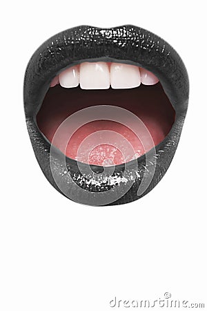 Close-up view of female wearing black lipstick with mouth open over white background Stock Photo