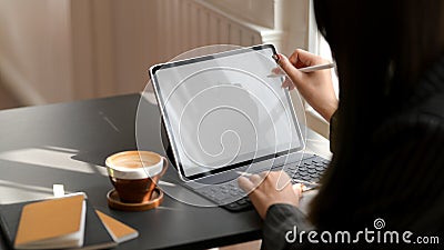 Close up view of female working on mock up digital tablet in comfortable workplace Stock Photo