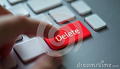 Close-up view finger poised on large red DELETE key. Action data removal. Digital interactions need decisive action. Urgent tech Stock Photo