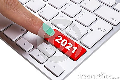 Close up view of a finger pushing on a red 2021 button of computer keyboard. Computer notebook keyboard with 2021 key. Finger pres Stock Photo