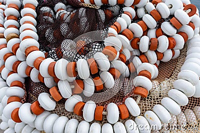 Close up view of fishing and trawling nets bunched together on a dock in harbor Stock Photo