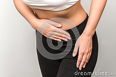 Close up view of a fitness woman having abdominal pain Stock Photo
