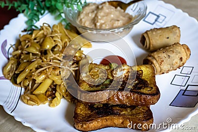 Close-up view of fried bread with tasty pasta, vegetable roll and sweet khir on a plate Stock Photo