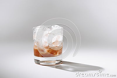 close up view of glass of cold brewed coffee with ice cubes on white tabletop Stock Photo