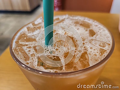 Close up view of grapefruit iced tea in a cup with straw Stock Photo