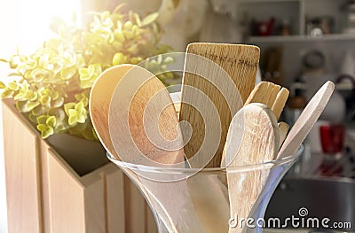 Close-up view of a group of wooden kitchen utensils inside a glass container Stock Photo