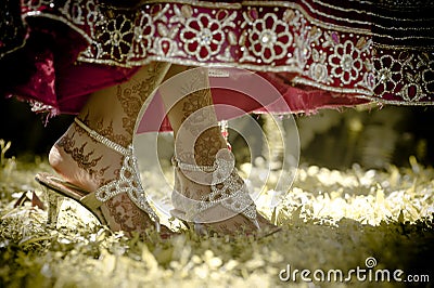 Close up view of Hindu bride's painted feet dancing in garden Stock Photo