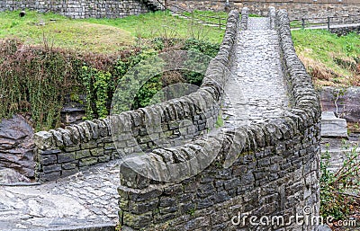 Close up view of historic stone bridge from Roman times in a secluded mountain valley Stock Photo