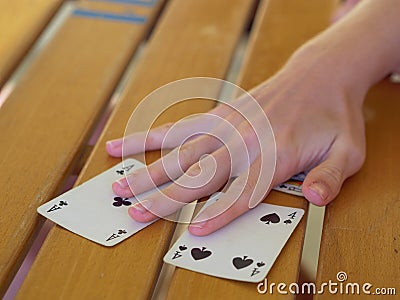 Close-up View of Italian Playing Cards Moved by Players Hands above a Table with Wooden Staves Stock Photo